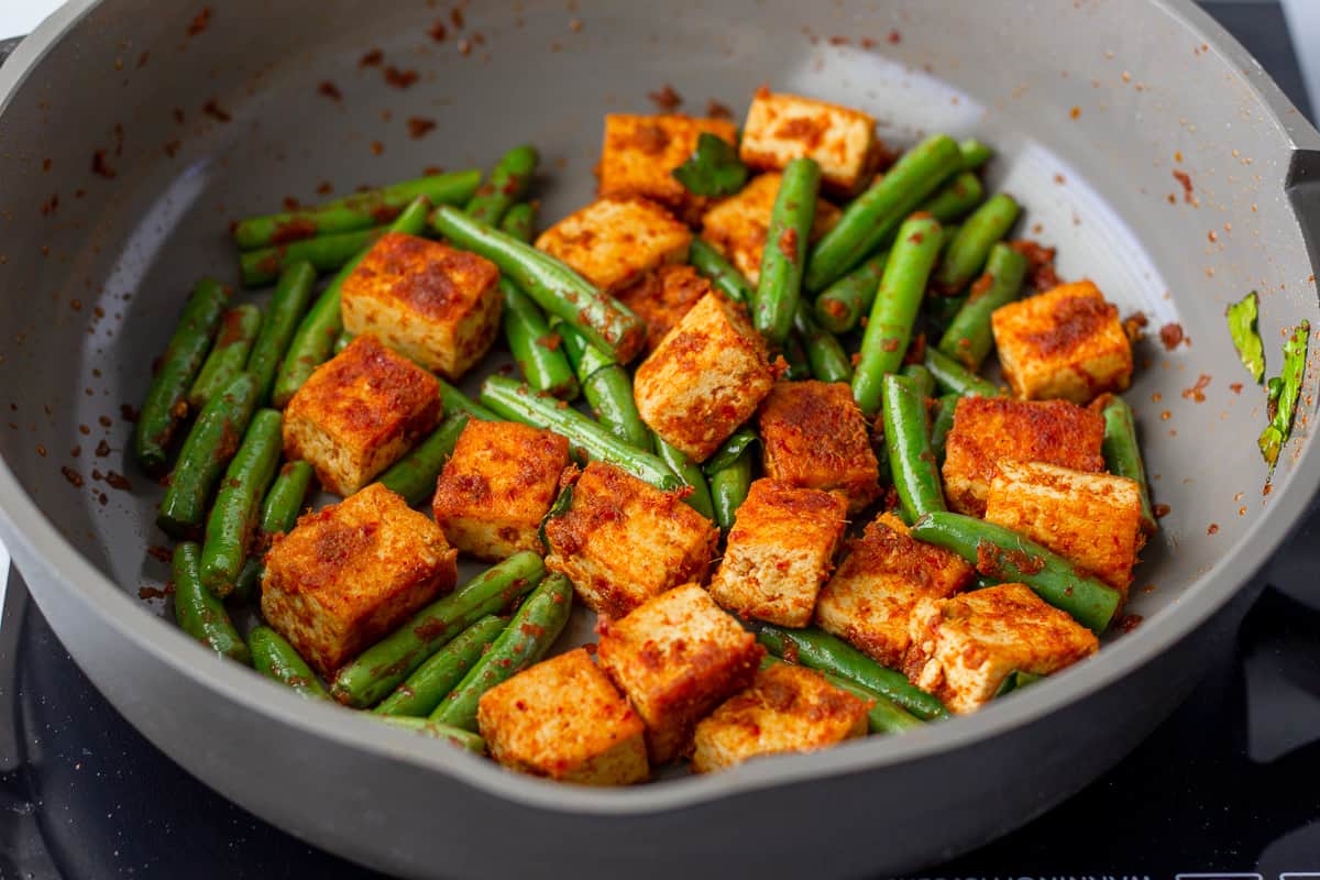 Red curry tofu stir fry in a skillet.