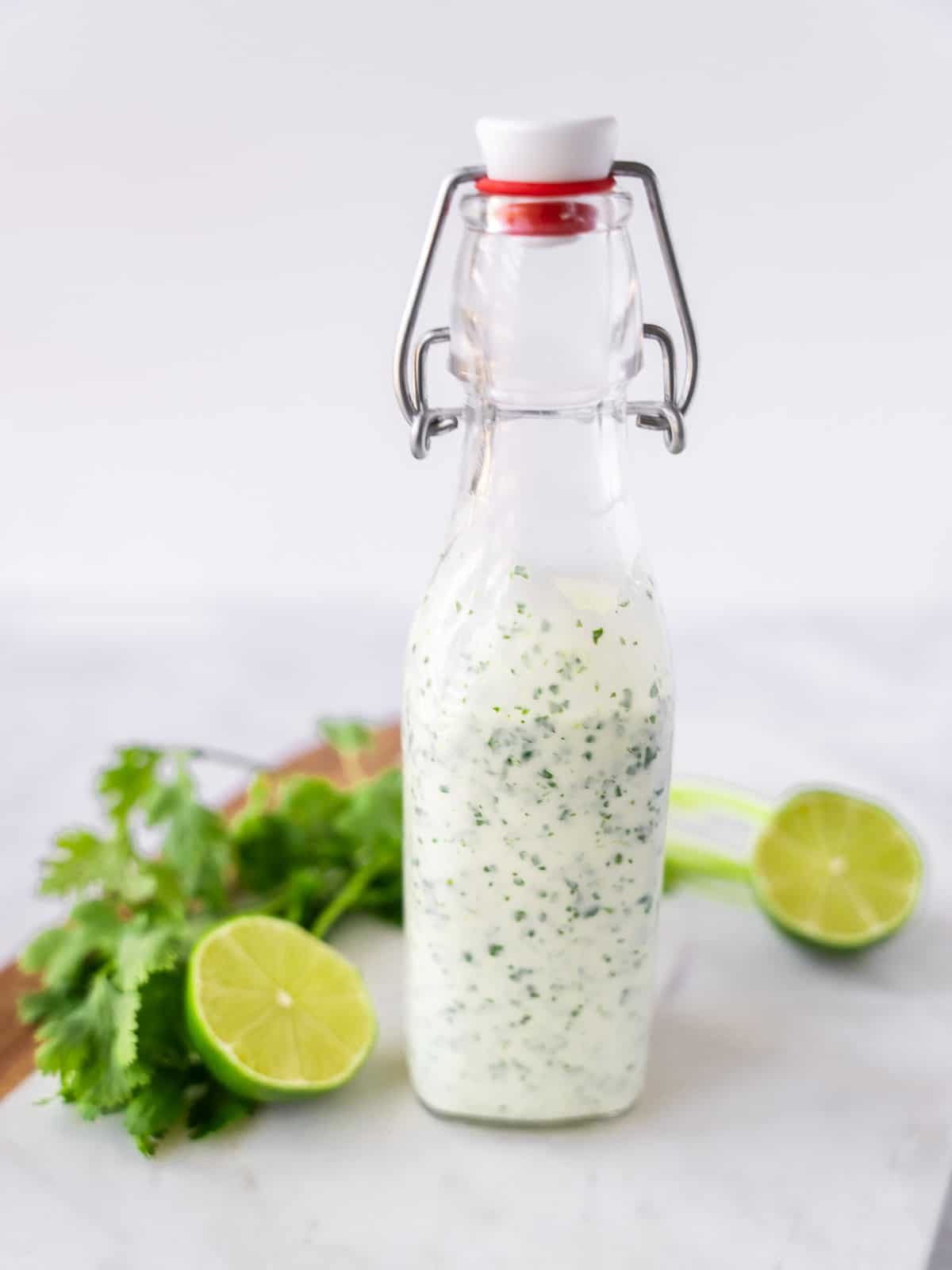 Yogurt cilantro lime dressing in a glass bottle.