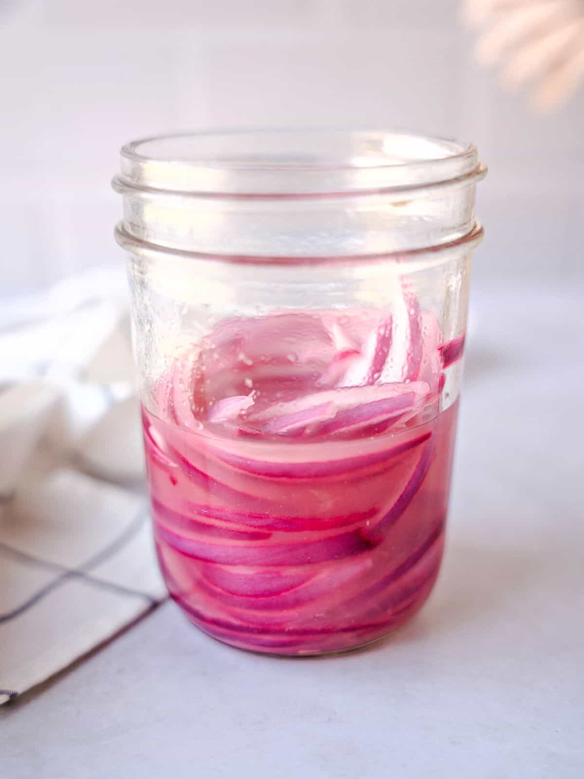 Pickled red onions in a mason jar.