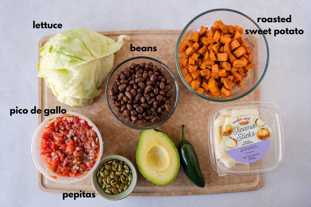 Ingredients for Taco salad on a cutting board.