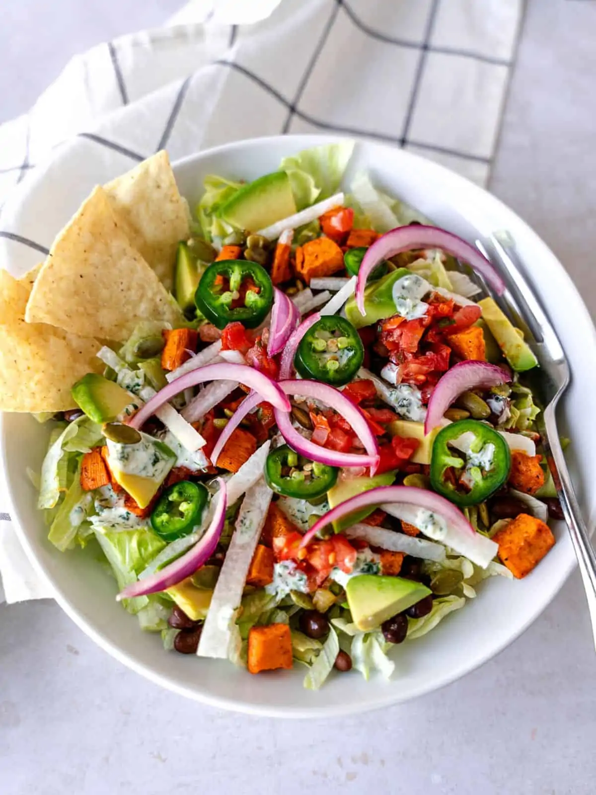 Overhead view of taco salad in a white bowl.