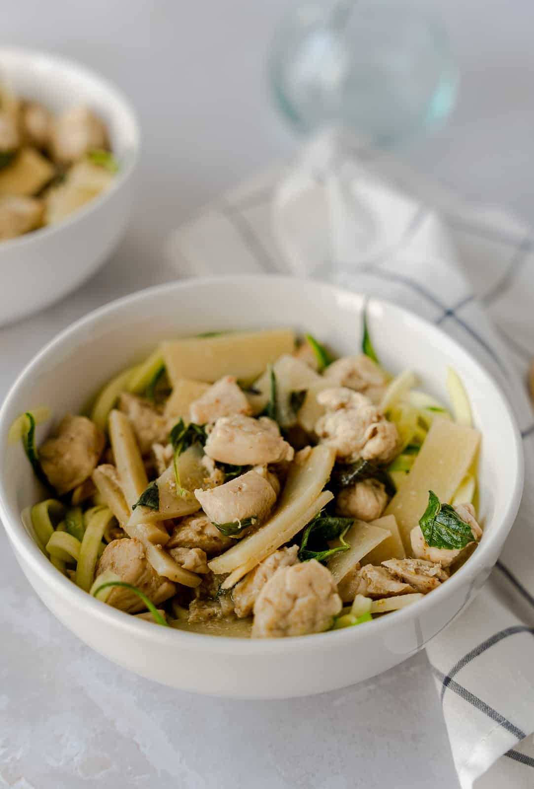 Green curry chicken in a white bowl.