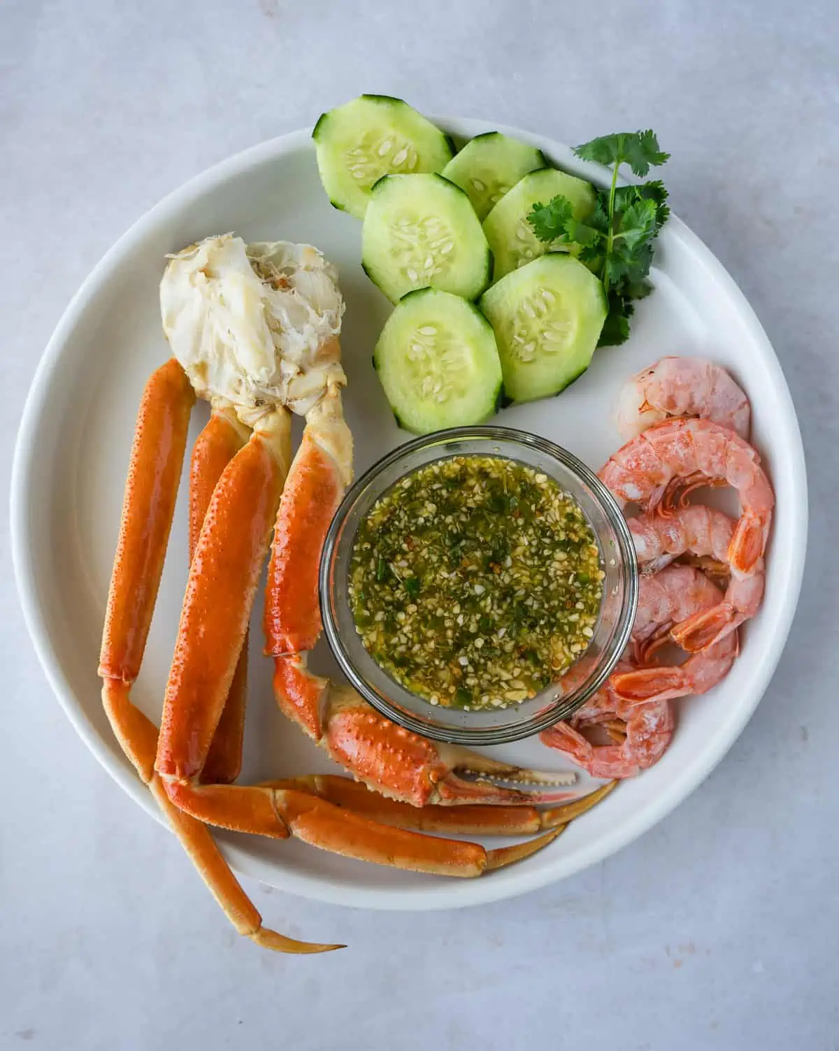 Overhead view of crab, shrimp, and dipping sauce.