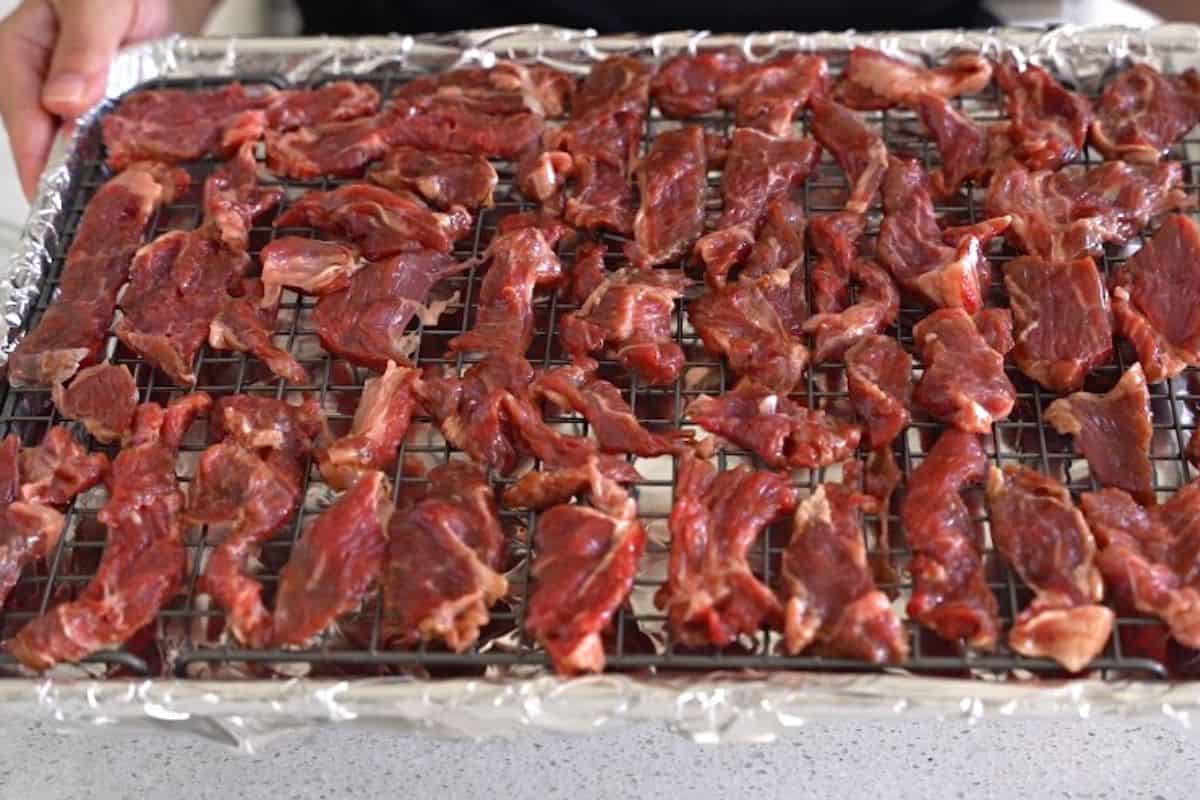 Uncooked beef on a baking sheet.