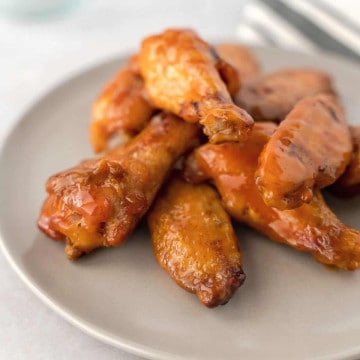 Feature image of wings covered in buffalo sauce.