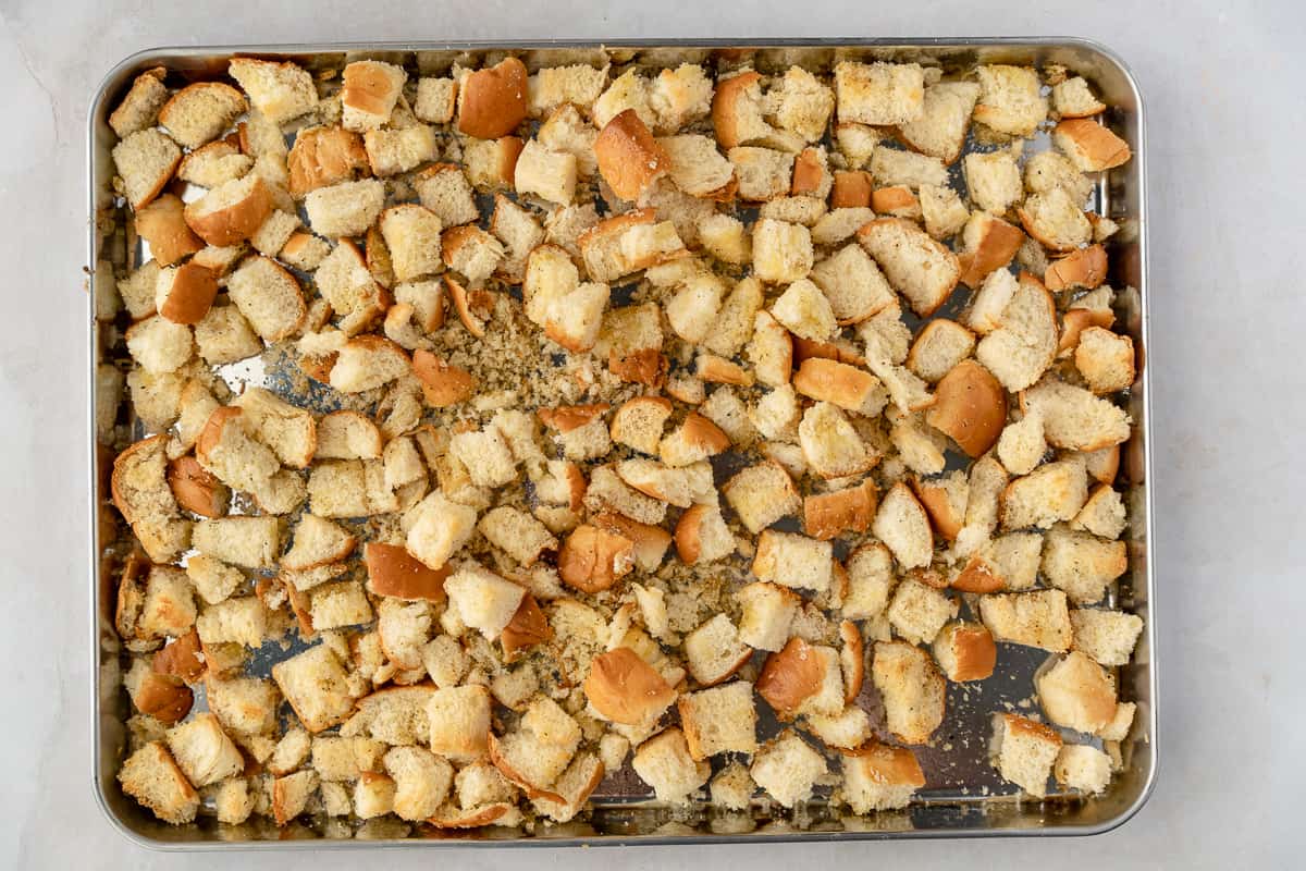 Toasted bread cubes on a baking sheet.