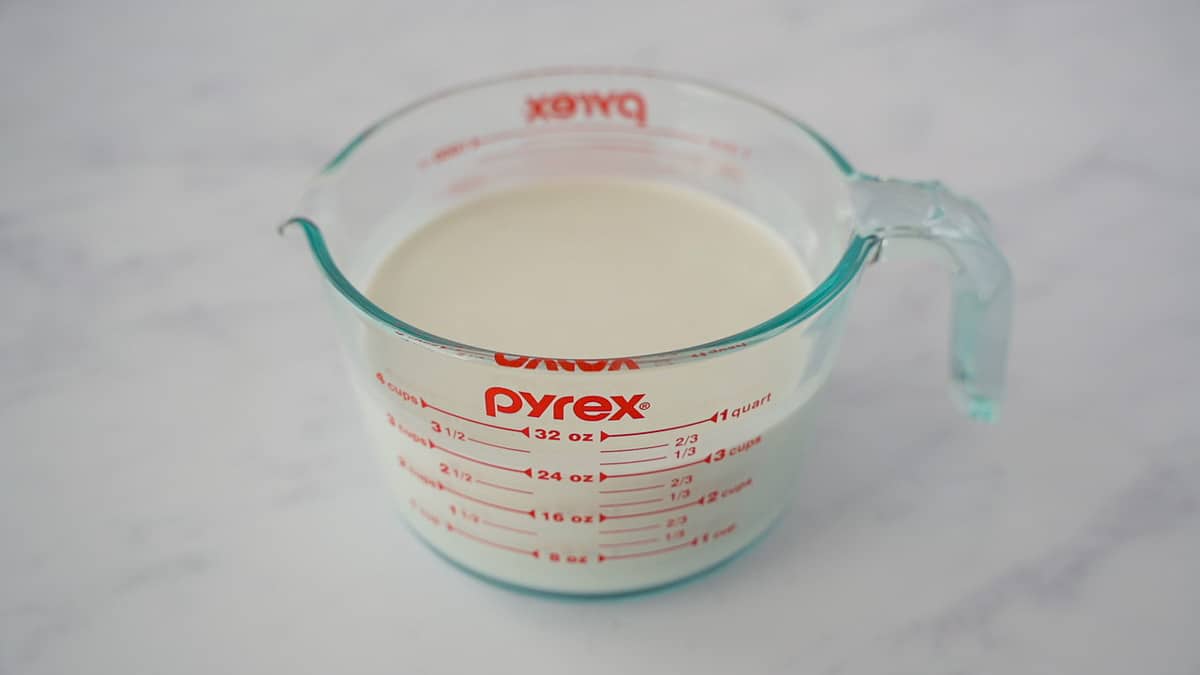 Coconut milk in a measuring cup.