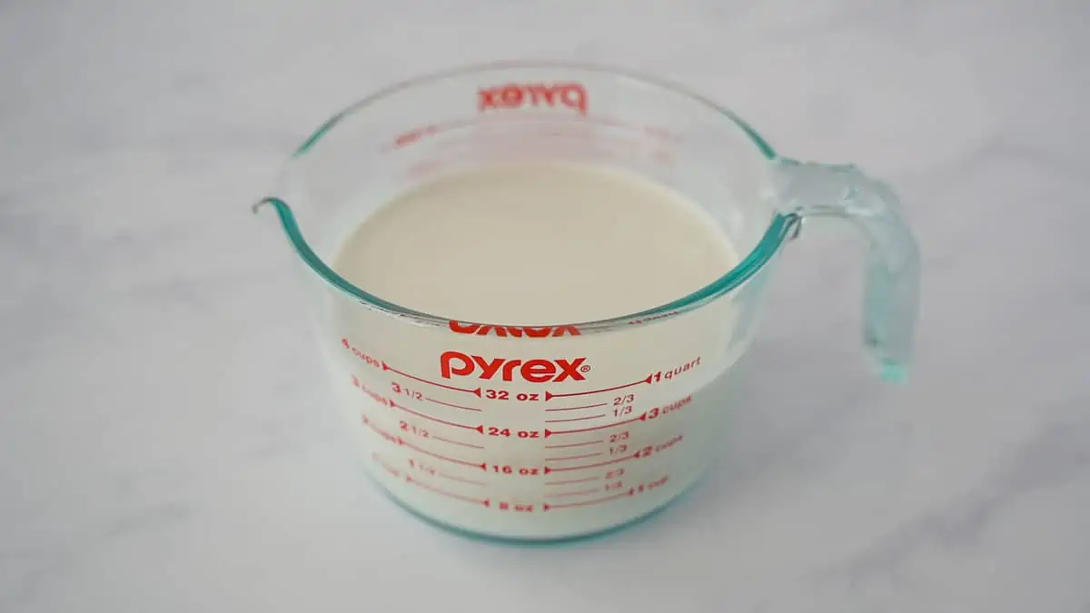 Coconut milk in a measuring cup.