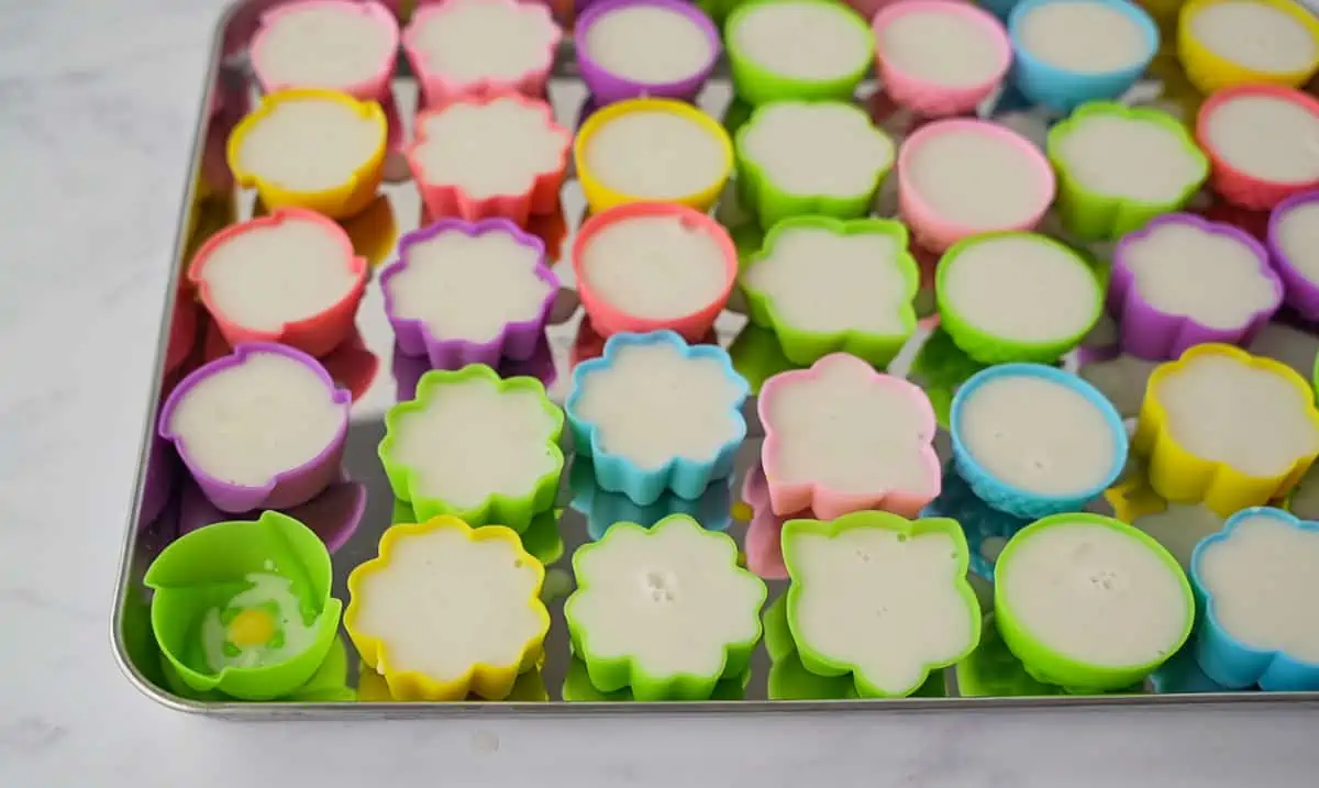 Flower silicon molds filled with coconut mixture.