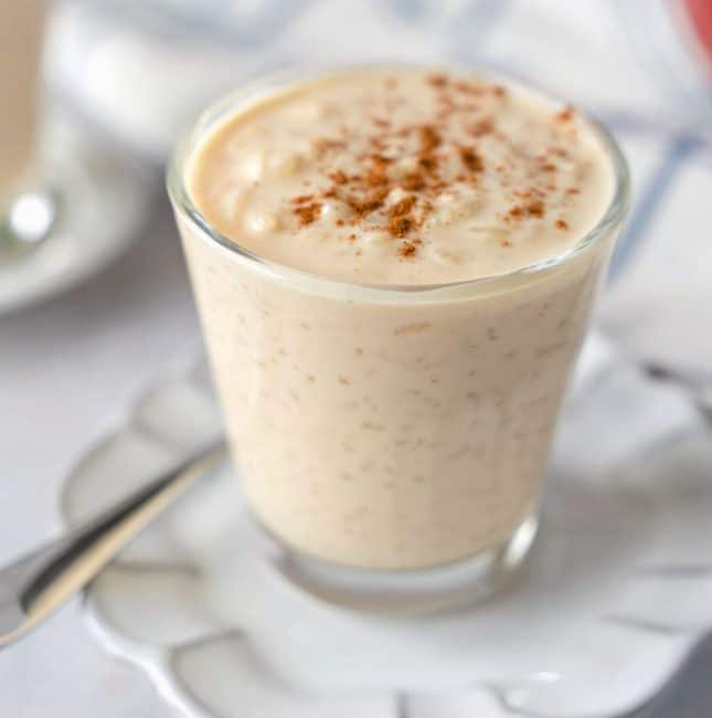 Feature image of arroz con leche in a glass cup.