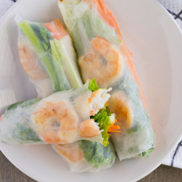 Feature image of rice paper rolls with shrimp on a plate.