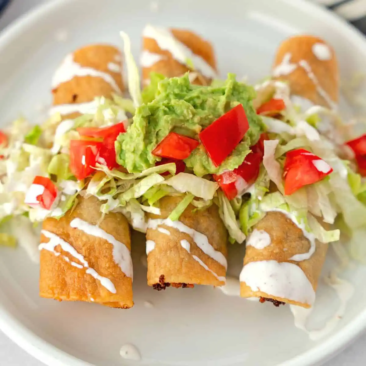 Feature image of taquitos with toppings.
