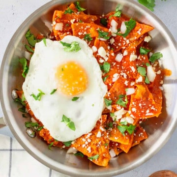 Feature image of red chilaquiles topped with a fried egg.