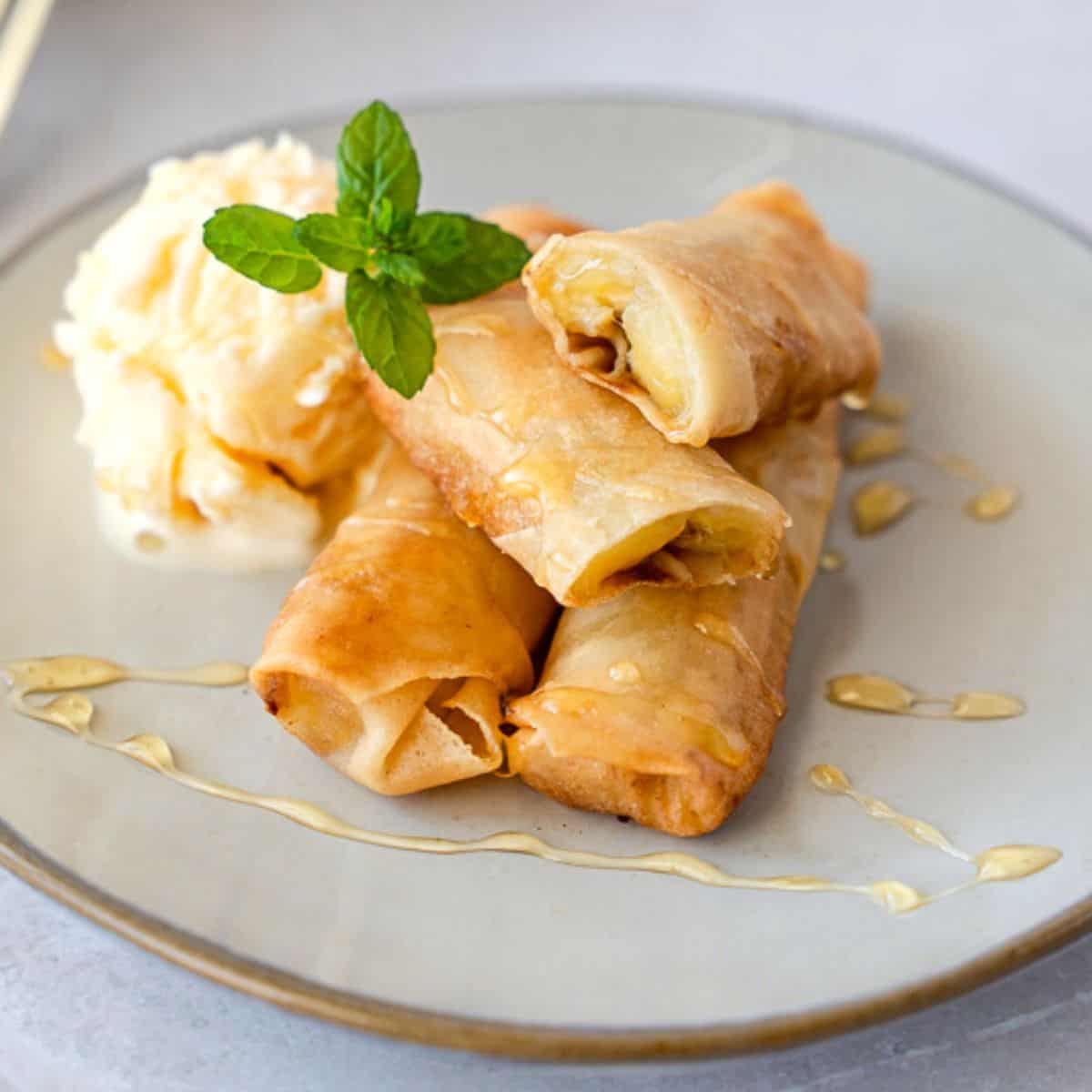 https://thaicaliente.com/wp-content/uploads/2023/02/banana-spring-roll-feature.jpg