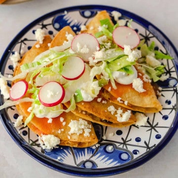 Feature image of tacos dorados on a blue plate.