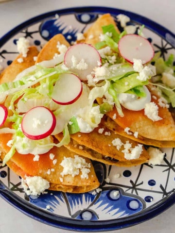 Feature image of tacos dorados on a blue plate.