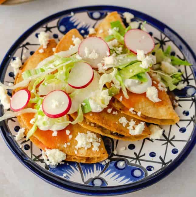 Feature image of tacos dorados on a blue plate.