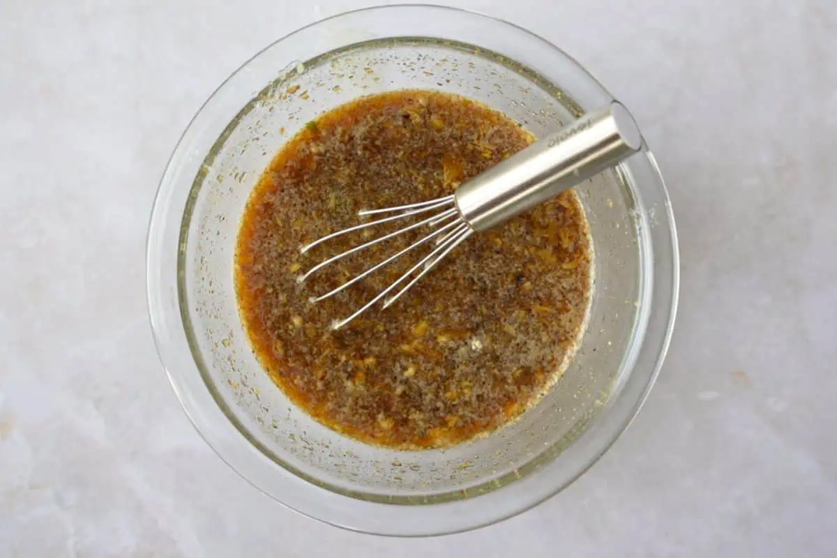 Marinade for moo ping in a bowl with a small whisk.