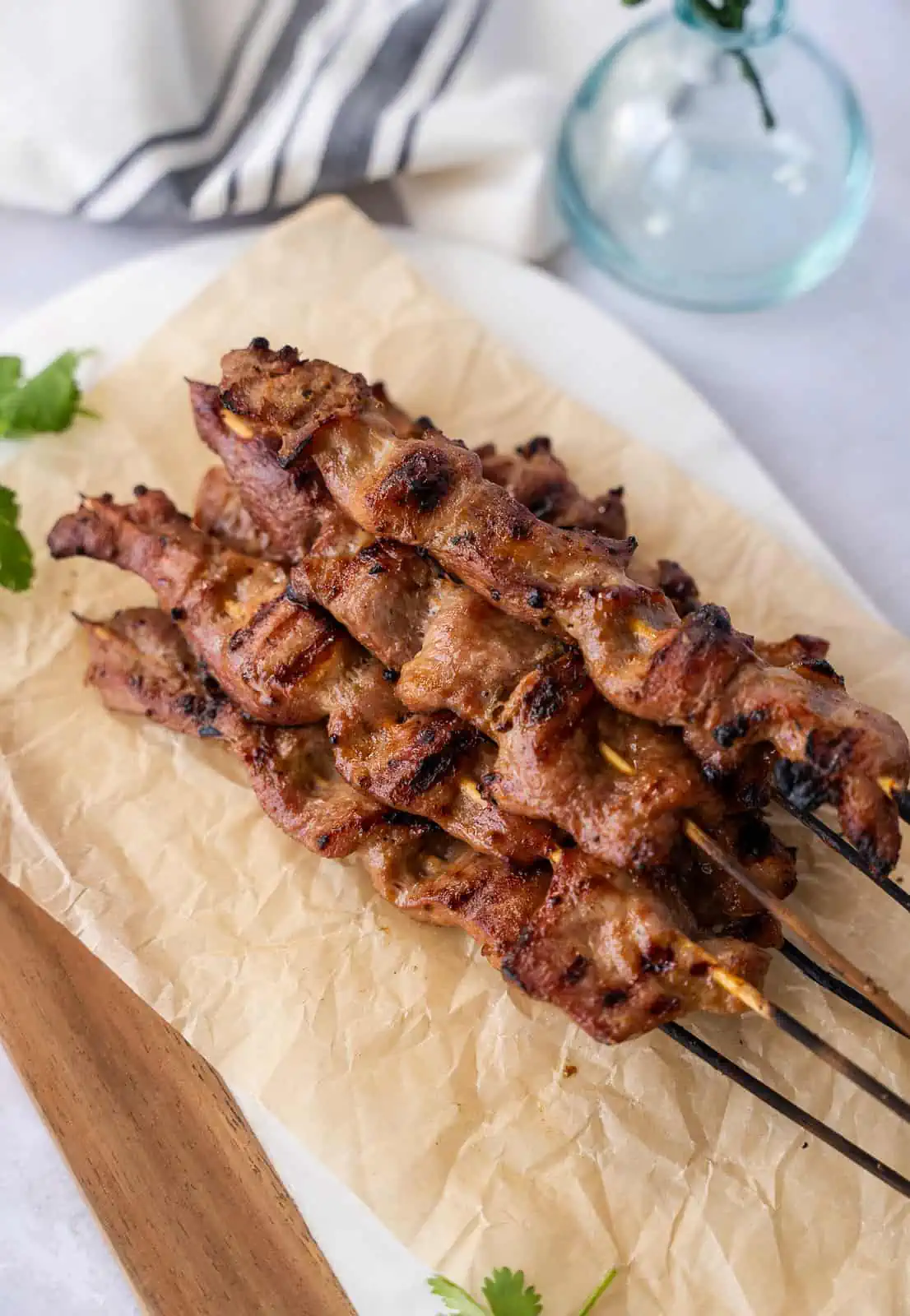 Cooked Moo Ping on a plate with parchment paper.