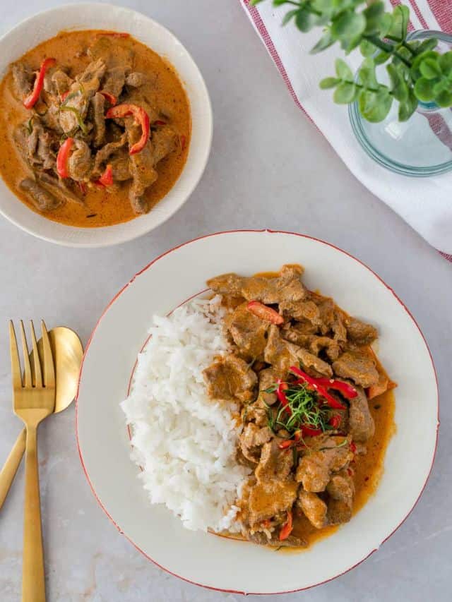 Beef Panang Curry on a plate with rice on the side