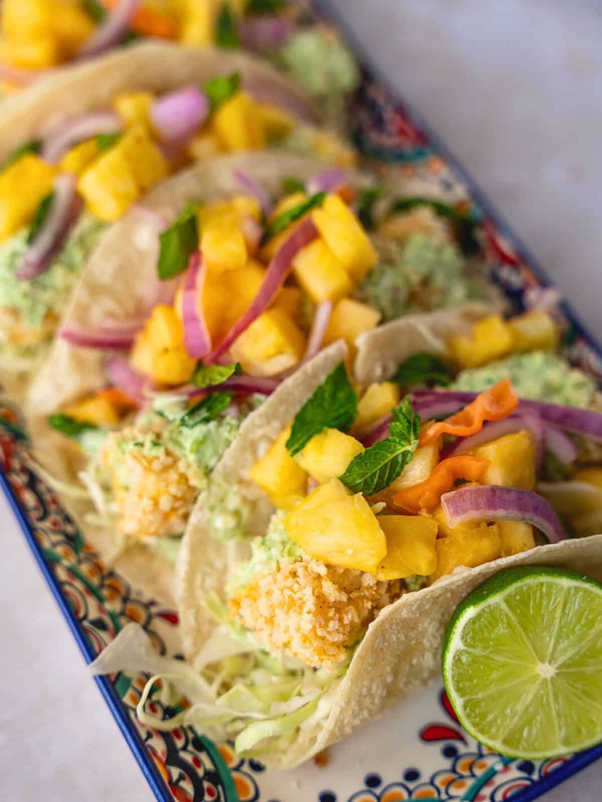 Up close view of crispy fish tacos with pineapple salsa.