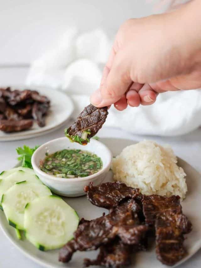 Easy Thai Beef Jerky dipping in sauce