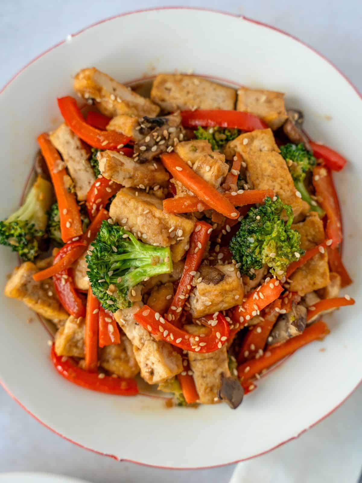 Overhead view of Tofu and Vegetable stir fry on a plate.