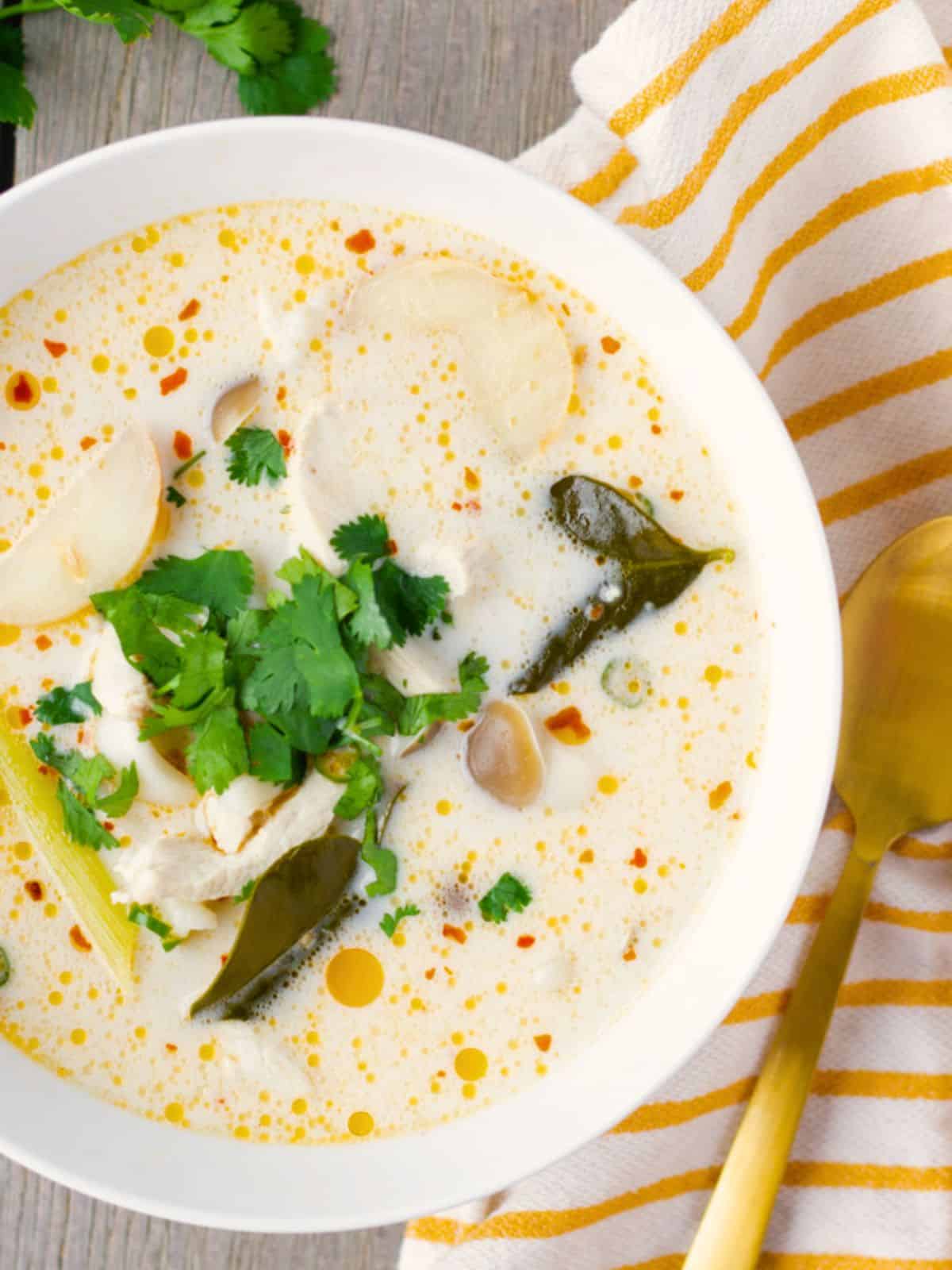 Bowl of tom kha gai garnished with cilantro.