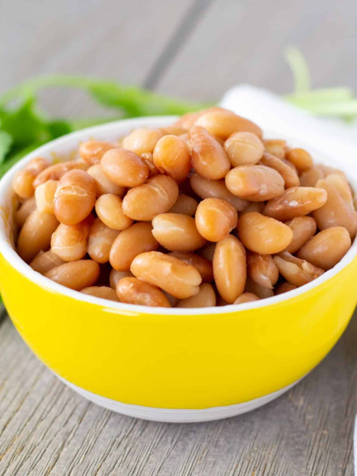Whole Peruvian beans in a yellow bowl.