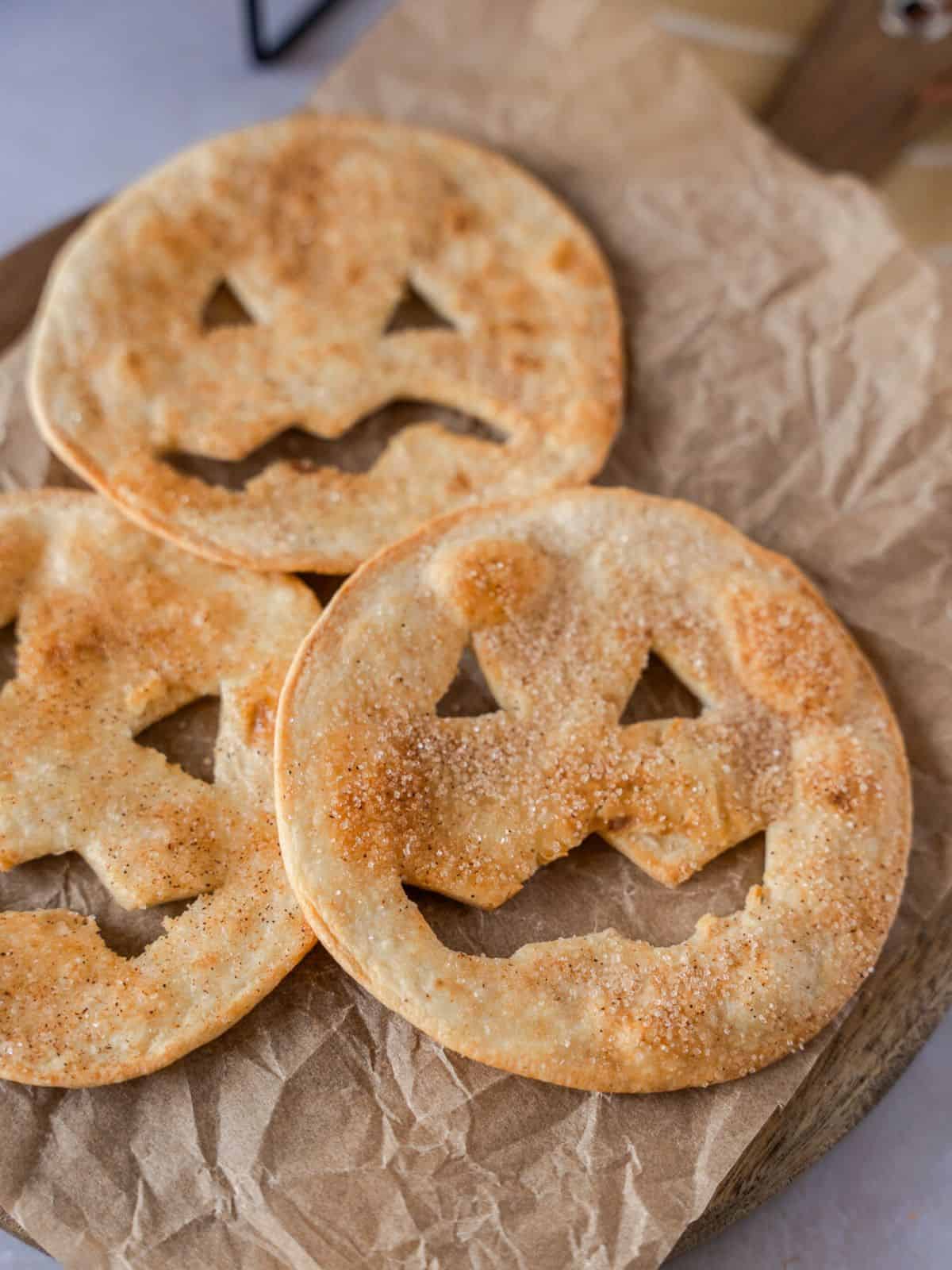 Flour tortillas cut like jack o lanterns and dusted with cinnamon and sugar.