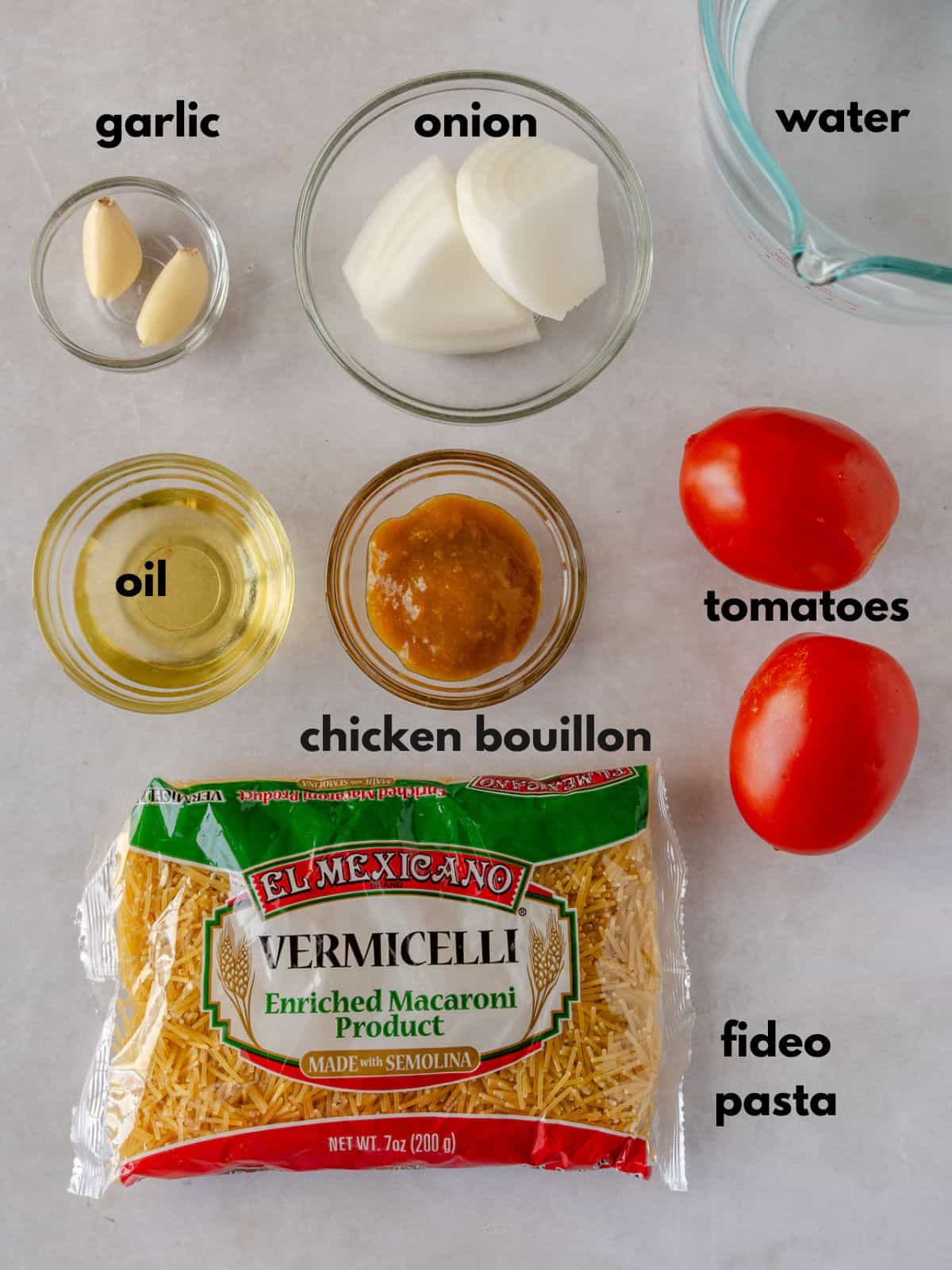 Ingredients with text, (garlic, onion, water, oil, chicken bouillon, tomatoes, fideo pasta).