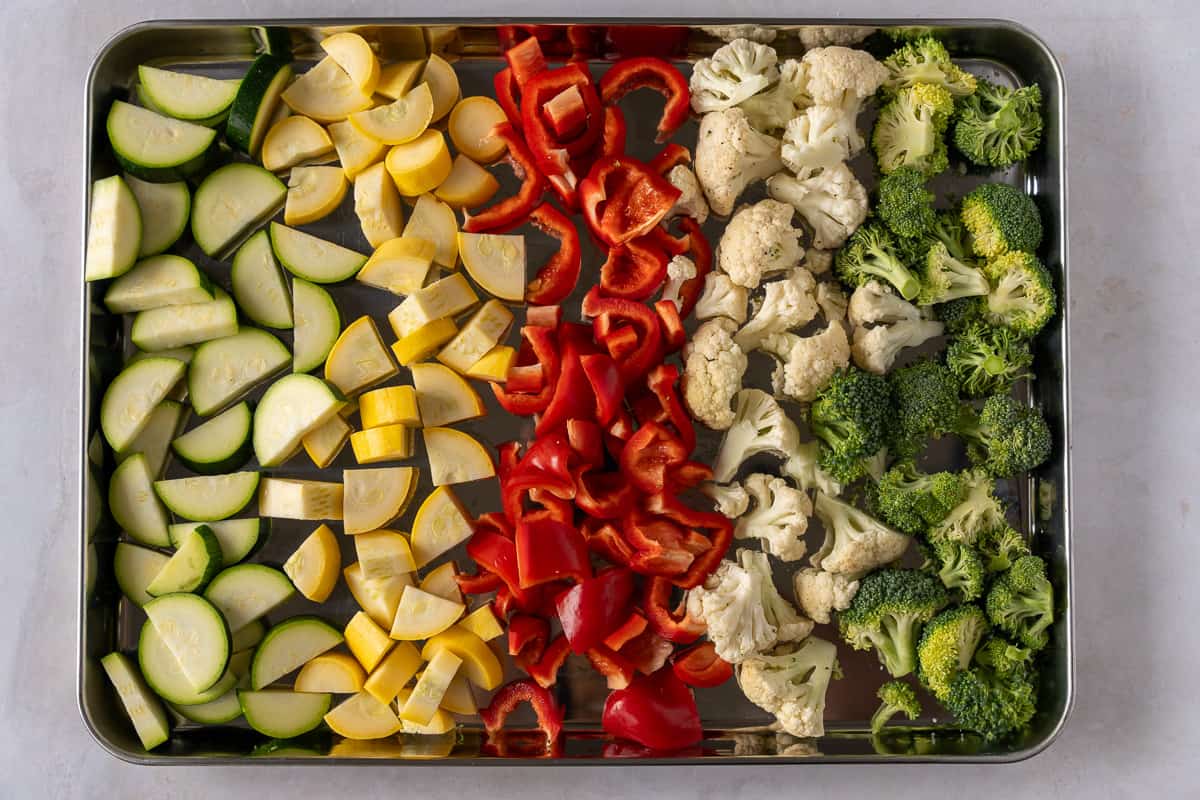 Chopped raw vegetables on a baking sheet.