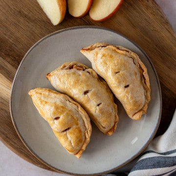 Feature image of three baked apple empanadas.