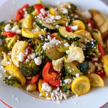 Feature image of roasted vegetables topped with crumbly cheese.