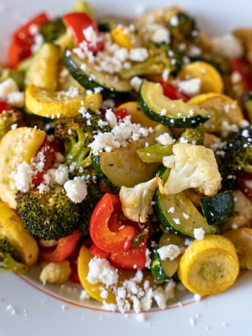 Feature image of roasted vegetables topped with crumbly cheese.