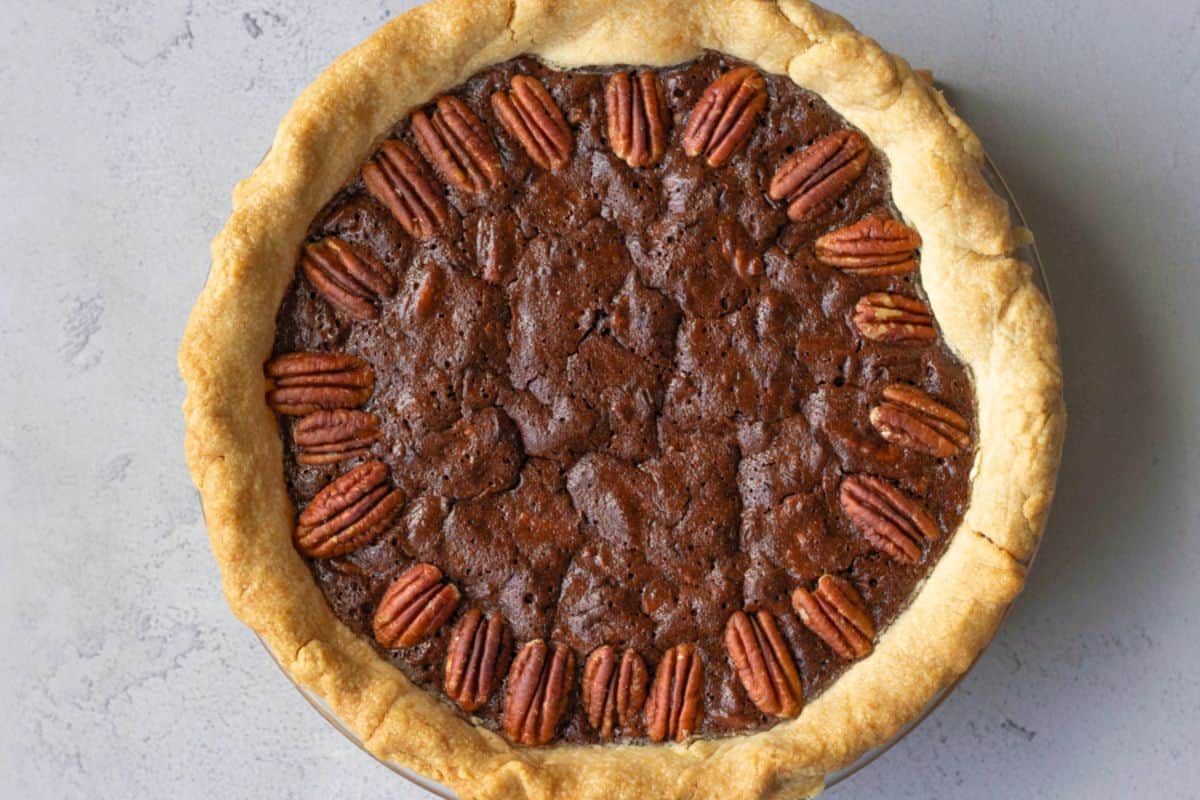 A whole Mexican chocolate pecan pie in a pie dish.