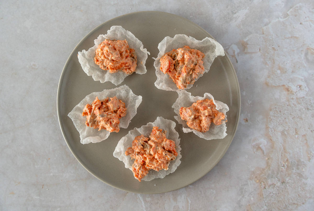 Salmon salad on rice paper chips.