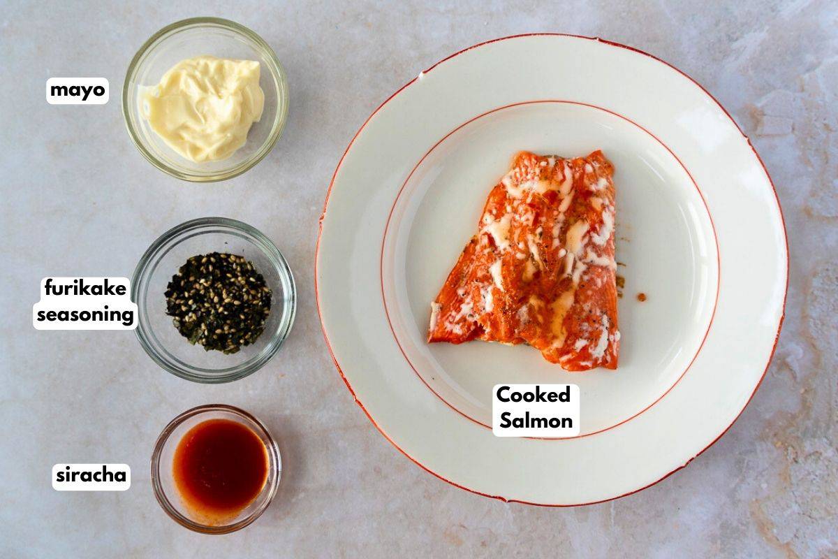 Ingredients with text for leftover salmon salad, (mayo, furikake, siracha, cooked salmon).