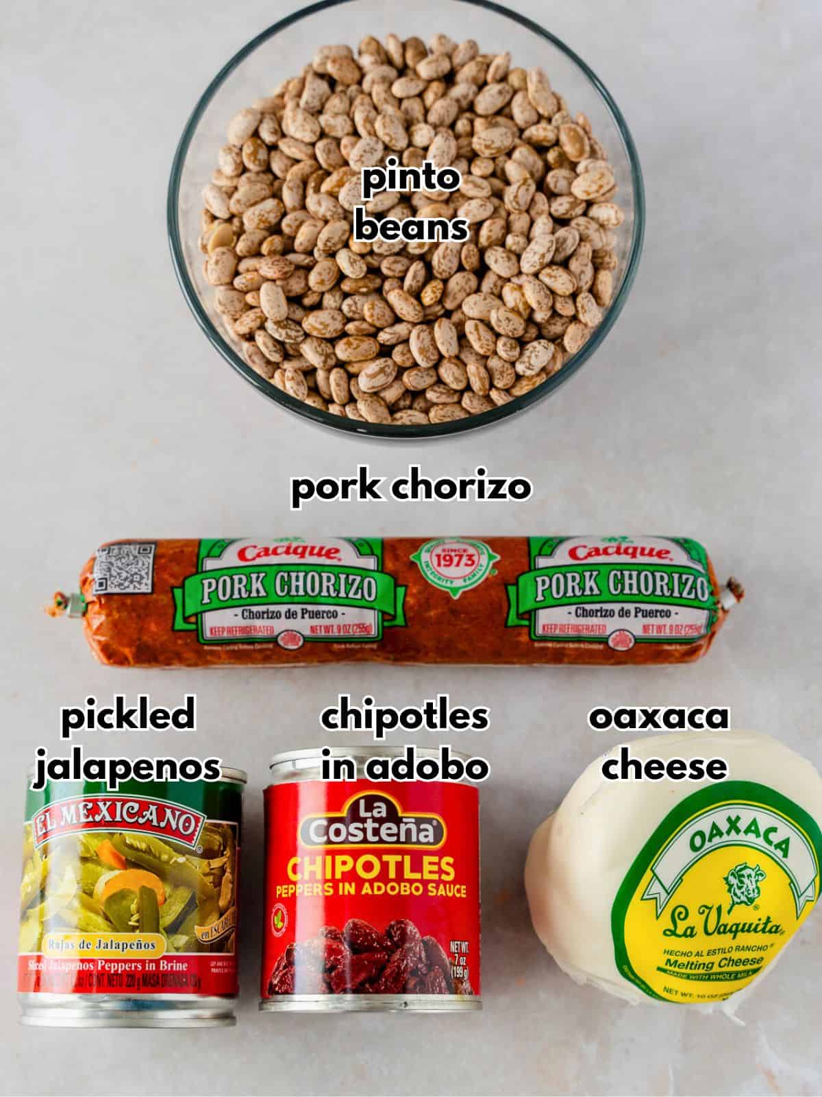 Ingredients with text, pinto beans, pork chorizo, pickled jalapenos, chipotles in adobo, Oaxaca cheese.