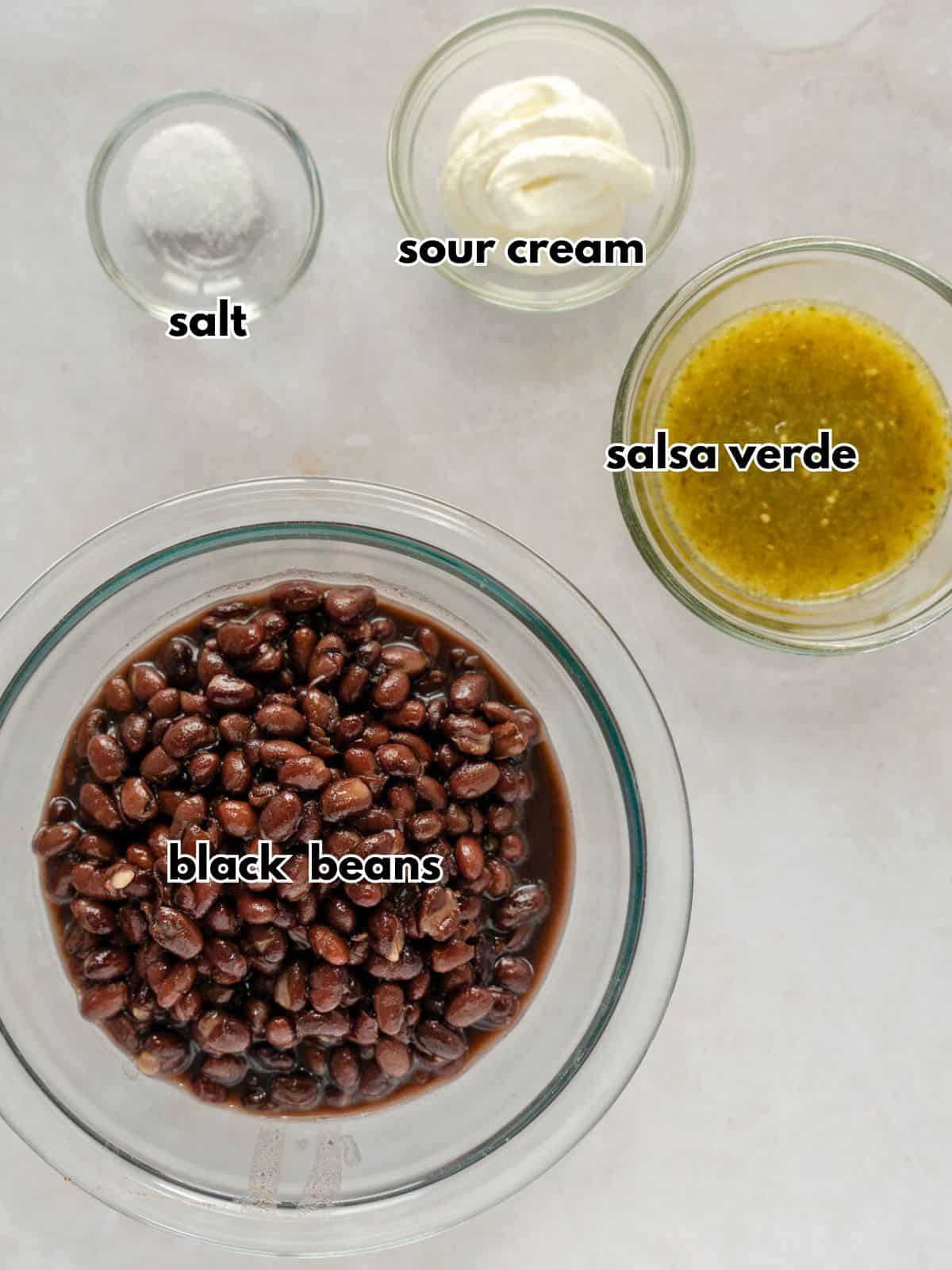 Ingredients labeled wit text- black beans, salsa verde, sour cream, and salt.