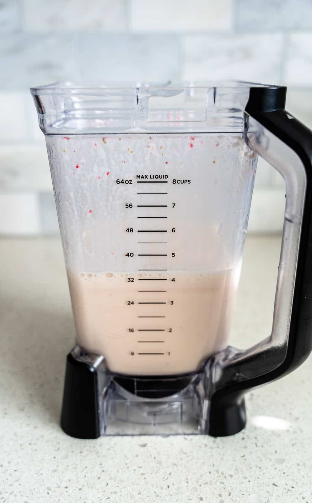 Blended strawberries and milk in a blender.