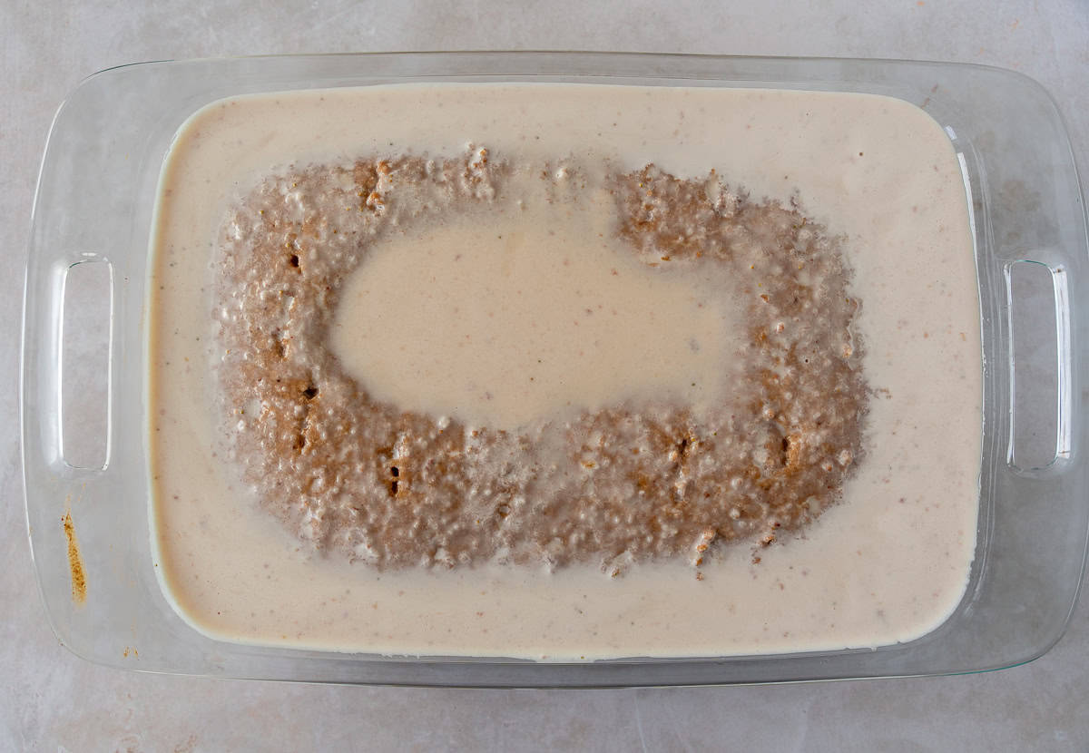 Milk soaked cake in a glass pan.