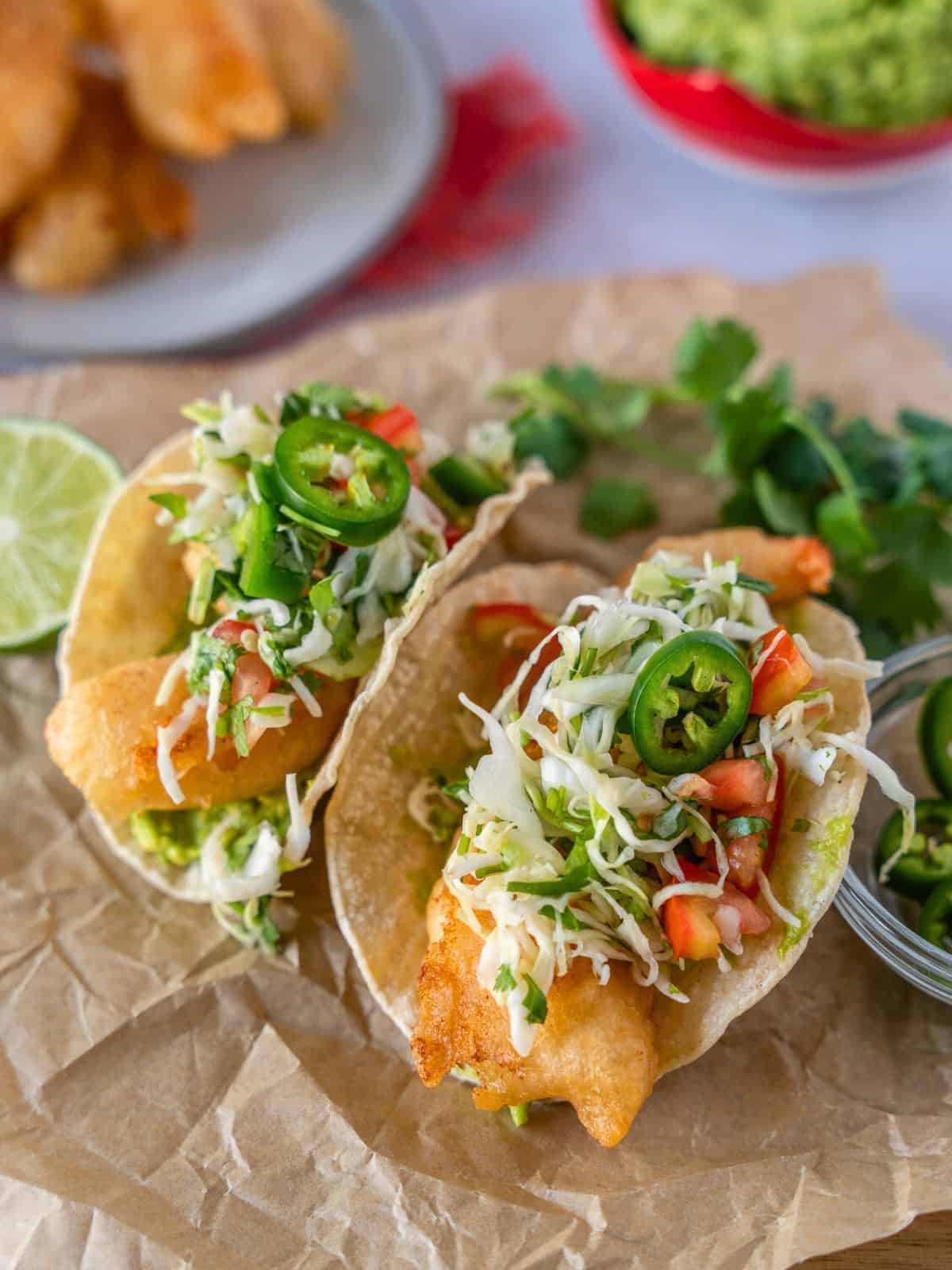 Beer battered shrimp tacos topped with cabbage slaw and jalapenos.