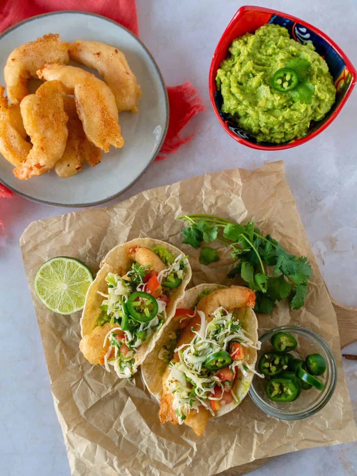 Overhead view of beer battered shrimp tacos and a plate of crispy shrimp.
