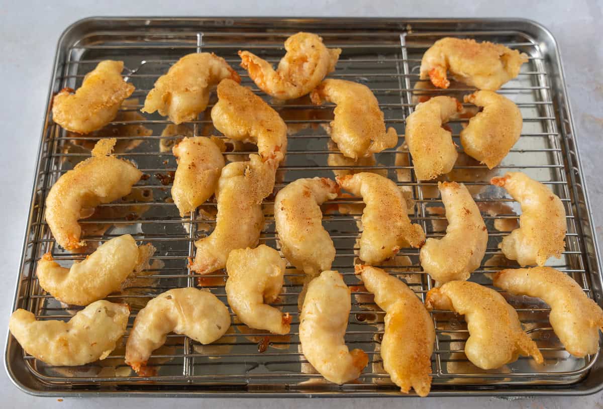 Fried shrimp on a baking rack.