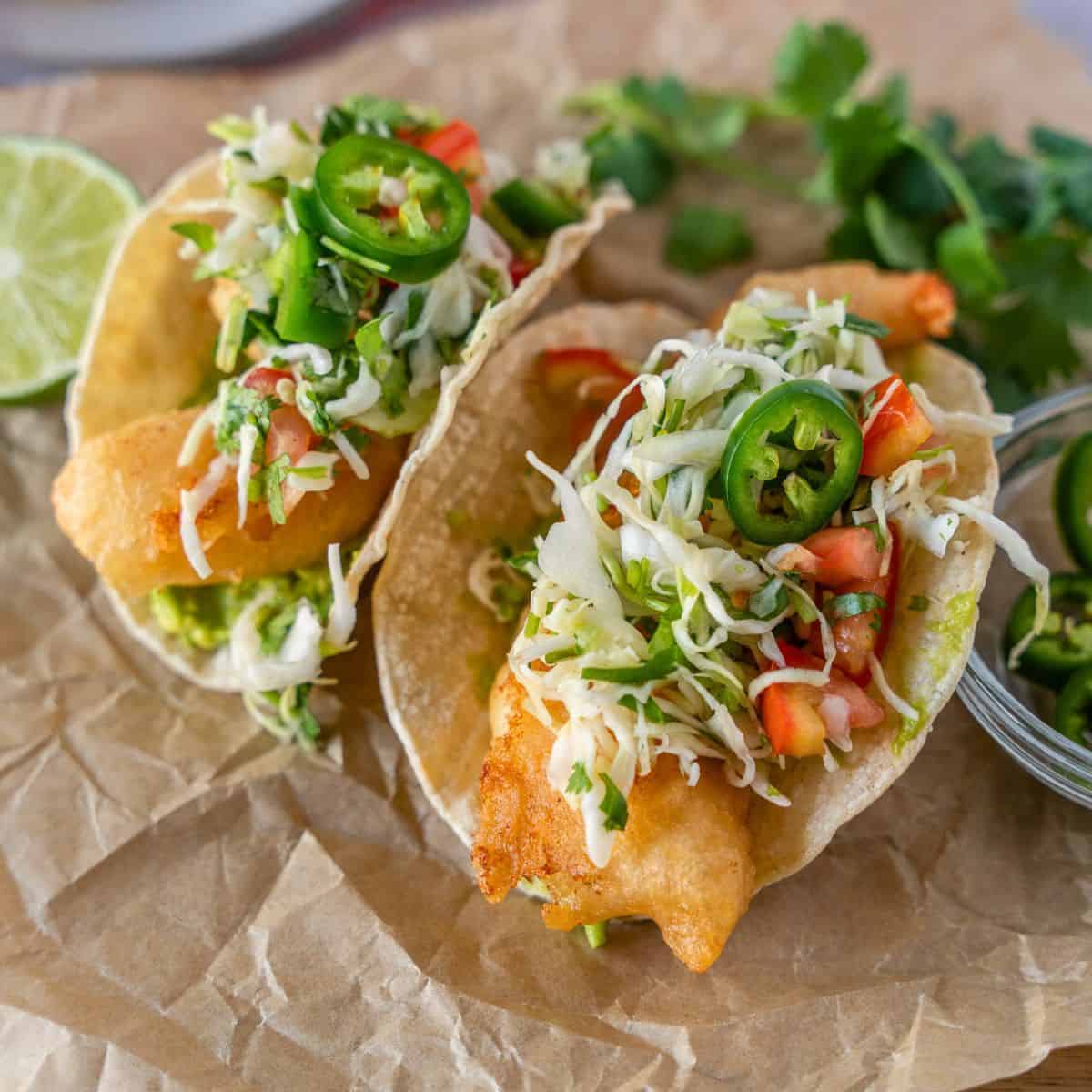 Feature image of two crispy shrimp tacos.