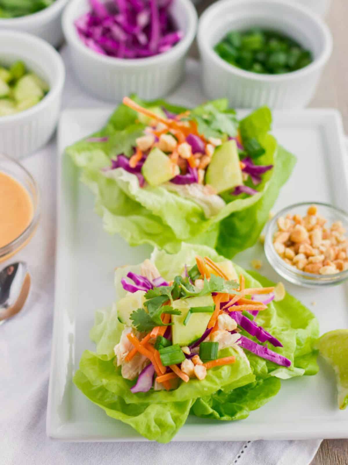 Assembled chicken lettuce wraps on a plate.