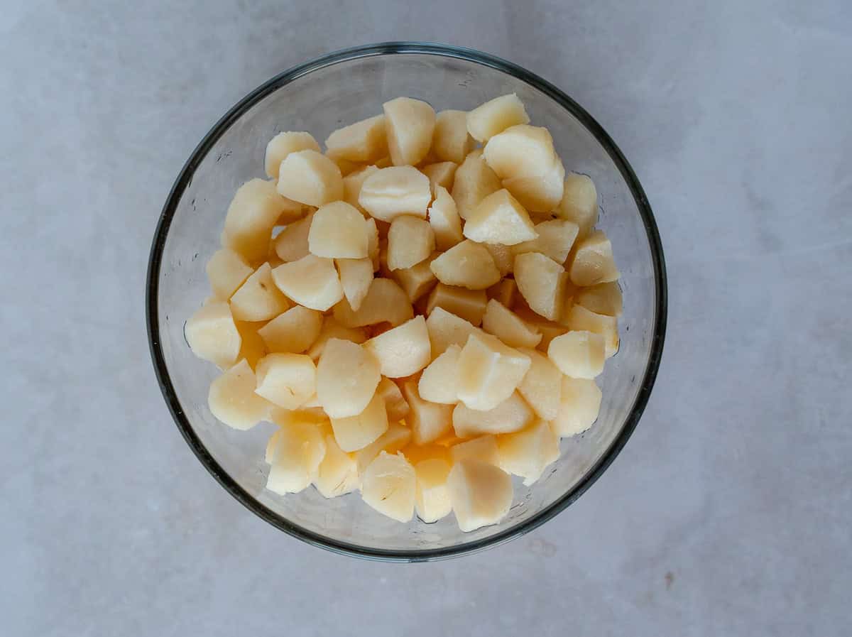 Diced water chestnuts in a glass bowl.