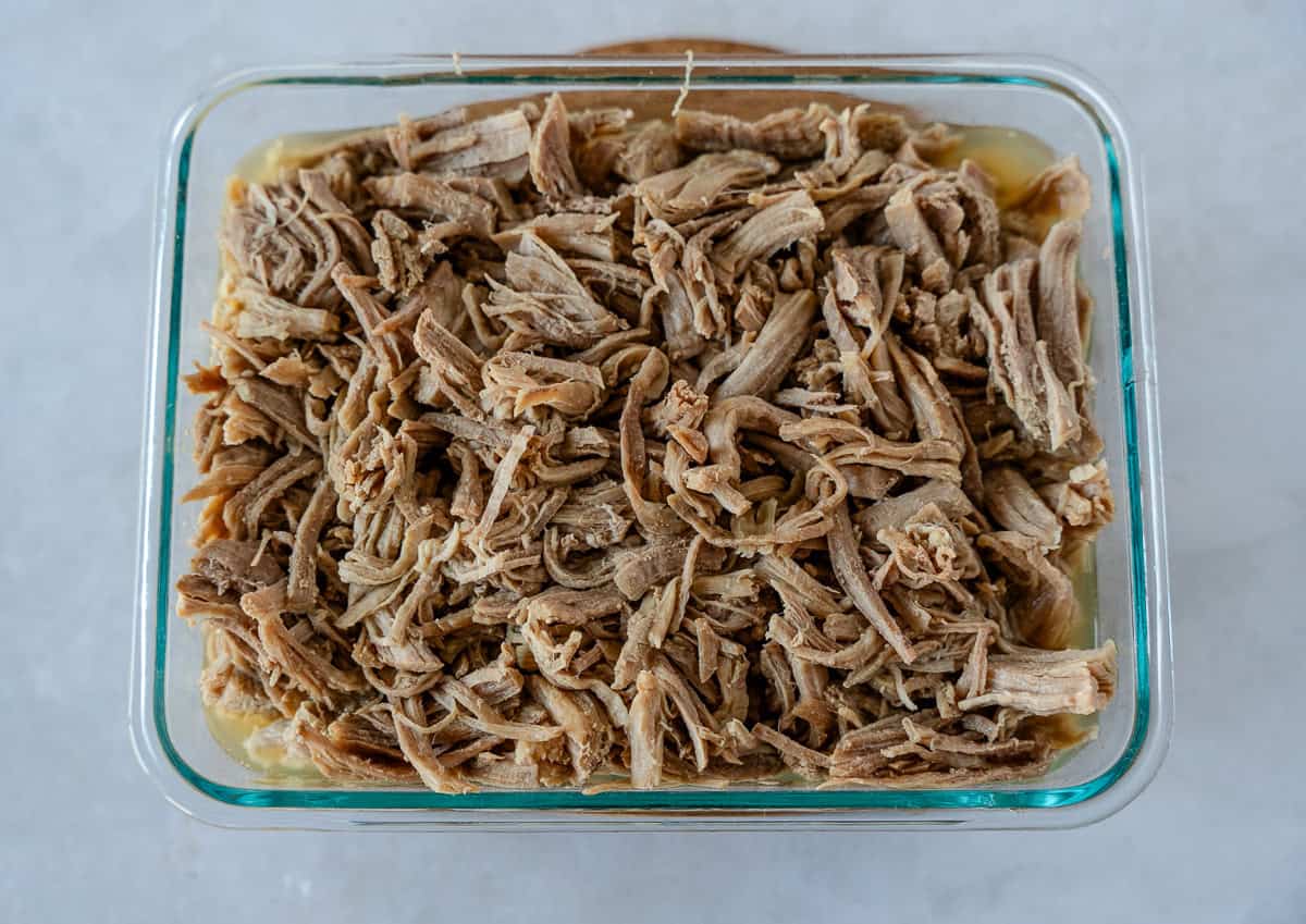 Shredded pork in a glass container.