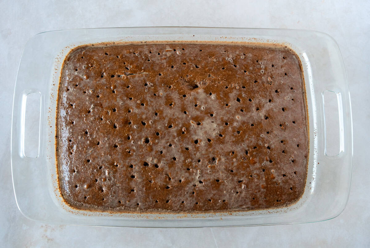 Chocolate cake with hole poked and tres leches mixture poured over.